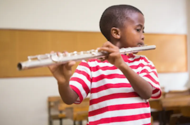 Flute lessons in Brighton MI child playing flute at Brighton Music Academy