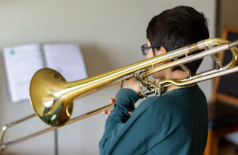 Trombone lessons in Brighton MI student playing trombone at Brighton Music Academy