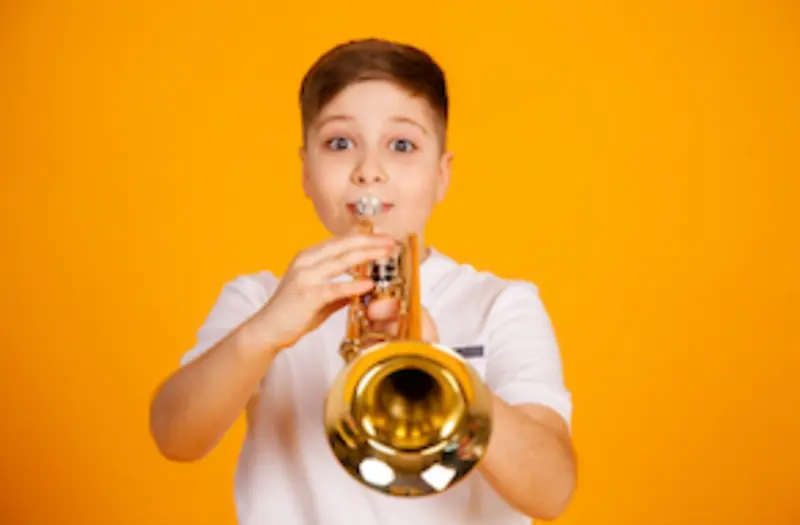 Trumpet lessons in Brighton MI child playing trumpet at Brighton Music Academy